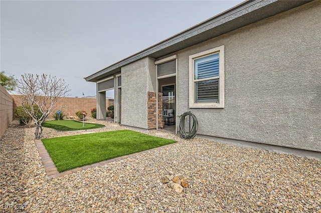 back of house featuring a patio, a fenced backyard, and stucco siding