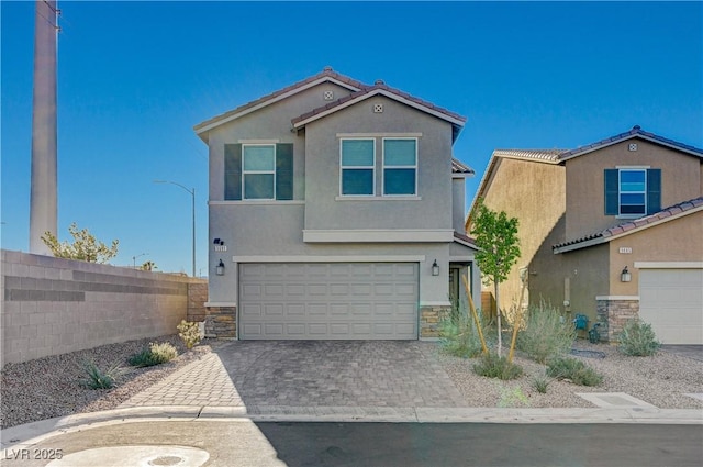 5691 Tinar St, Las Vegas, NV 89113 - view of front facade with stone siding, stucco siding, an attached garage, and driveway