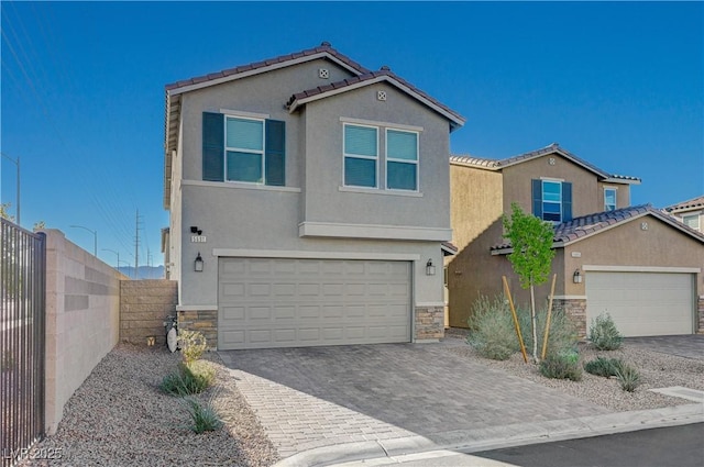 5691 Tinar St, Las Vegas, NV 89113 - view of front facade featuring stone siding, stucco siding, a tile roof, and decorative driveway