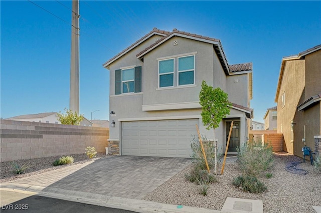 5691 Tinar St, Las Vegas, NV 89113 - view of front of home featuring an attached garage, stucco siding, decorative driveway, and a tile roof
