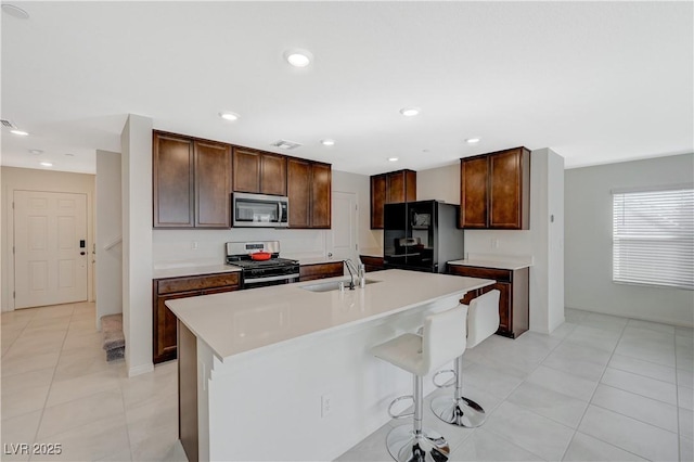 5691 Tinar St, Las Vegas, NV 89113 - kitchen with stainless steel appliances, a sink, light tile patterned flooring, light countertops, and recessed lighting