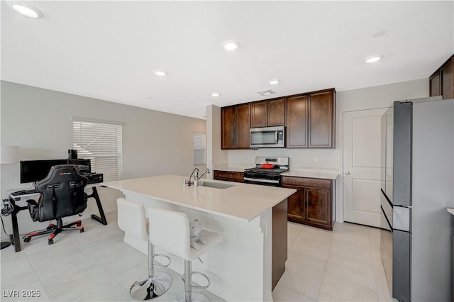 5691 Tinar St, Las Vegas, NV 89113 - kitchen with stainless steel appliances, a sink, dark brown cabinets, and recessed lighting