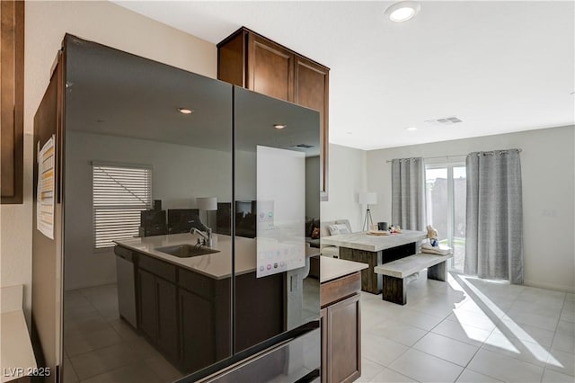 5691 Tinar St, Las Vegas, NV 89113 - kitchen featuring a sink, light tile patterned floors, stainless steel dishwasher, recessed lighting, and dark brown cabinets
