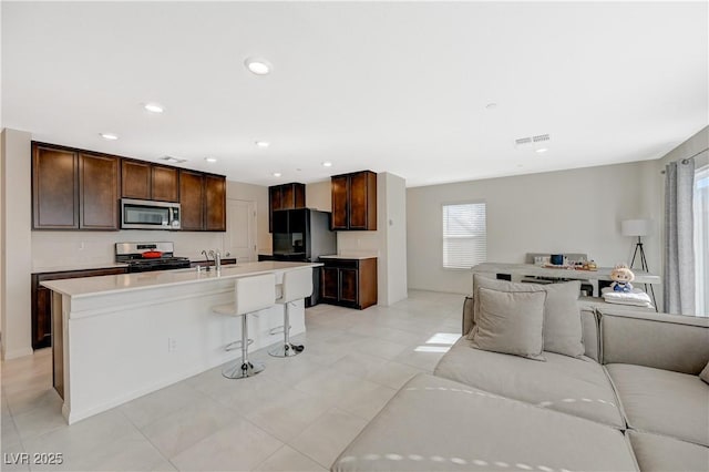 5691 Tinar St, Las Vegas, NV 89113 - kitchen with appliances with stainless steel finishes, open floor plan, plenty of natural light, light countertops, and recessed lighting