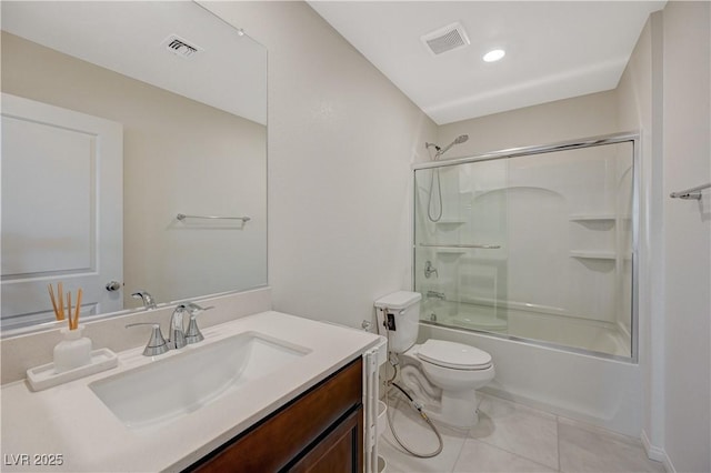 5691 Tinar St, Las Vegas, NV 89113 - bathroom with vanity, tile patterned flooring, toilet, and combined bath / shower with glass door