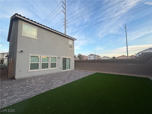 5691 Tinar St, Las Vegas, NV 89113 - rear view of house featuring stucco siding, a fenced backyard, and a patio