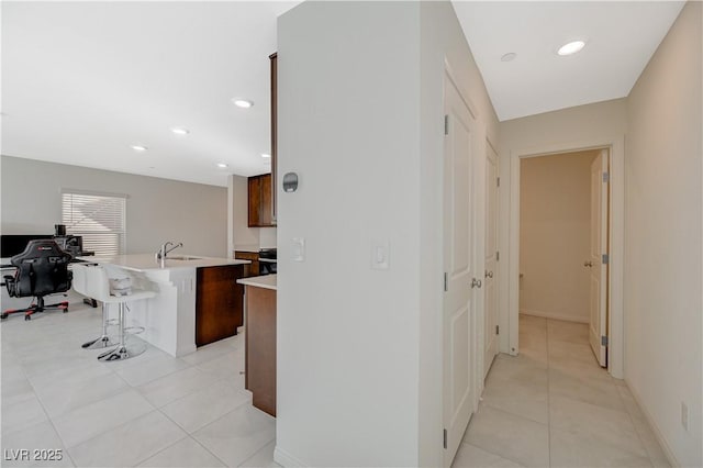 5691 Tinar St, Las Vegas, NV 89113 - corridor featuring a sink, light tile patterned floors, recessed lighting, and an office area