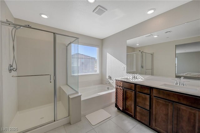5691 Tinar St, Las Vegas, NV 89113 - full bath featuring a bath, a shower stall, tile patterned floors, double vanity, and recessed lighting