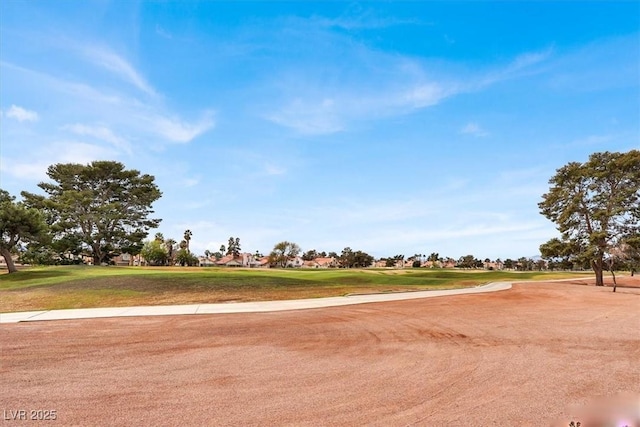 view of property's community with a yard and golf course view