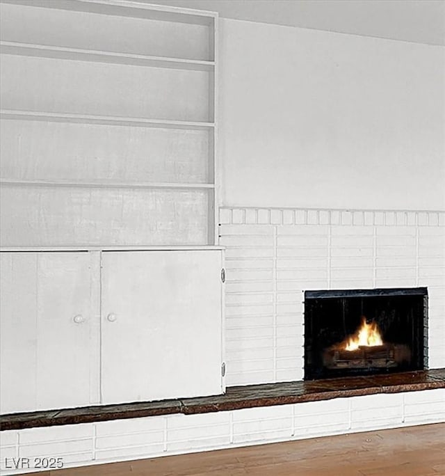 details with wood finished floors and a fireplace