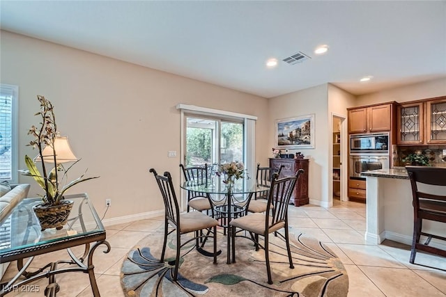 dining room featuring light tile patterned floors, visible vents, recessed lighting, and baseboards