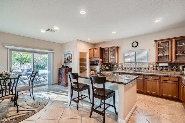 kitchen featuring a sink, visible vents, brown cabinets, and appliances with stainless steel finishes