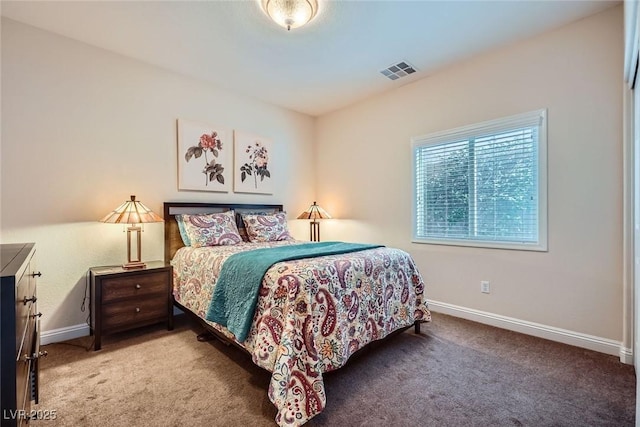 carpeted bedroom featuring visible vents and baseboards