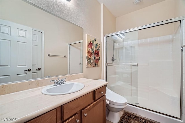 full bathroom with vanity, toilet, and a shower stall