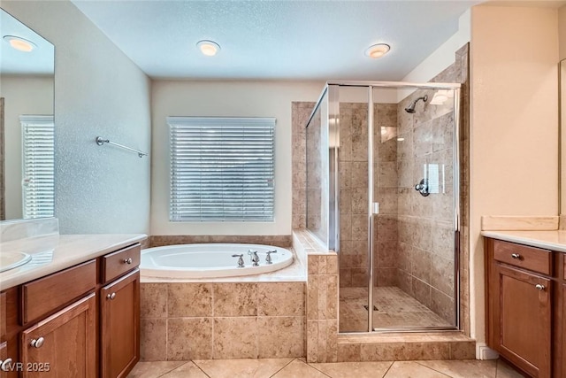 full bathroom with vanity, a garden tub, a stall shower, and tile patterned floors