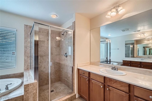 full bath featuring a sink, visible vents, and a shower stall