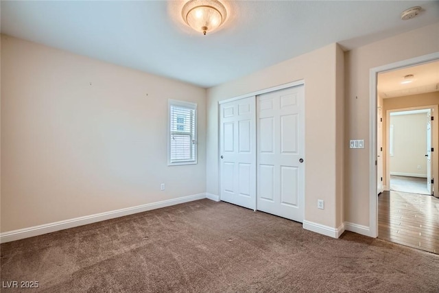 unfurnished bedroom with carpet, baseboards, and a closet