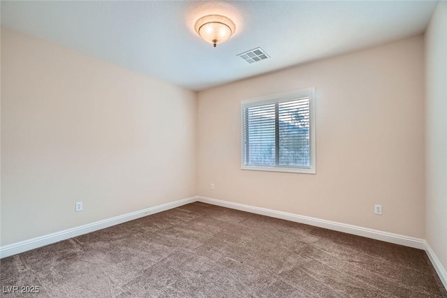 empty room featuring visible vents, carpet flooring, and baseboards