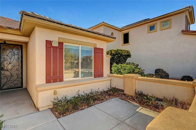 view of side of property with stucco siding