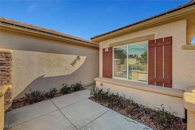 property entrance with stucco siding