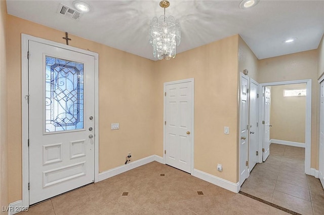 tiled foyer with recessed lighting, baseboards, visible vents, and a chandelier