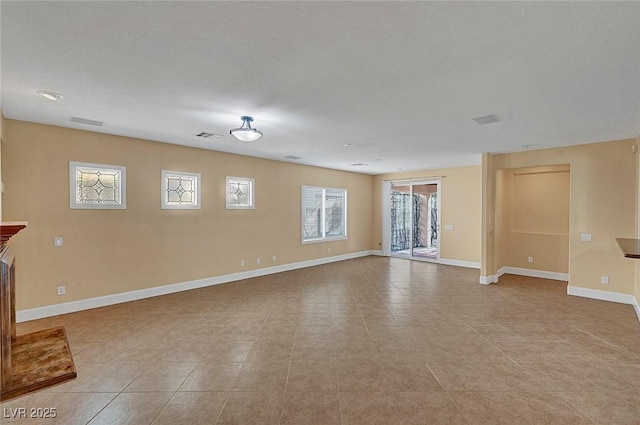 unfurnished living room with visible vents and baseboards