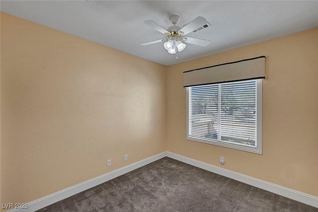 empty room featuring a ceiling fan, baseboards, and dark colored carpet