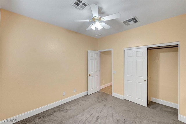 unfurnished bedroom featuring carpet flooring, baseboards, visible vents, and a closet