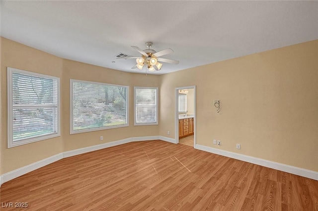 unfurnished room with visible vents, baseboards, light wood-style flooring, and a ceiling fan