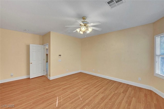 spare room with visible vents, ceiling fan, baseboards, and light wood-style floors