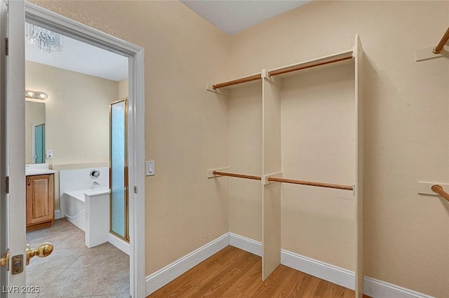 spacious closet with light wood finished floors