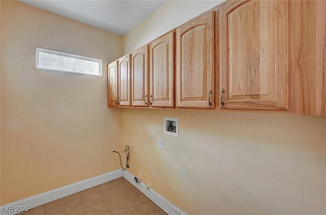 washroom with washer hookup, cabinet space, light tile patterned flooring, baseboards, and gas dryer hookup