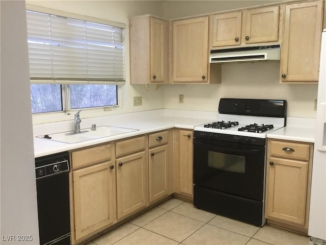 kitchen with light brown cabinets, under cabinet range hood, gas range, black dishwasher, and a sink