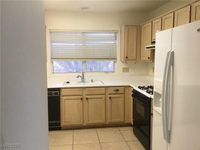 kitchen featuring black dishwasher, range hood, freestanding refrigerator, gas stove, and a sink