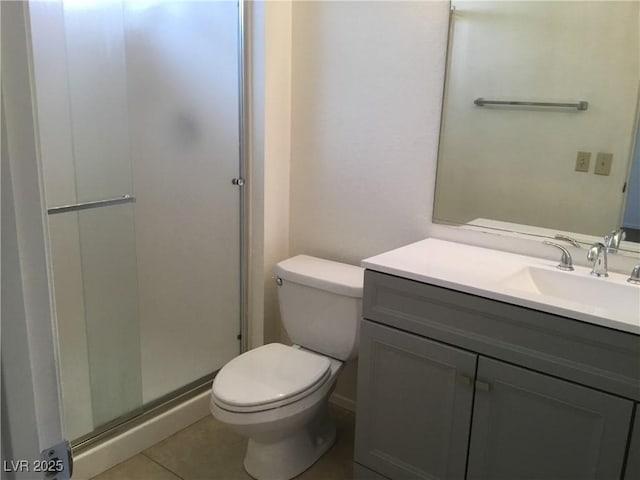 bathroom featuring tile patterned flooring, a shower stall, toilet, and vanity