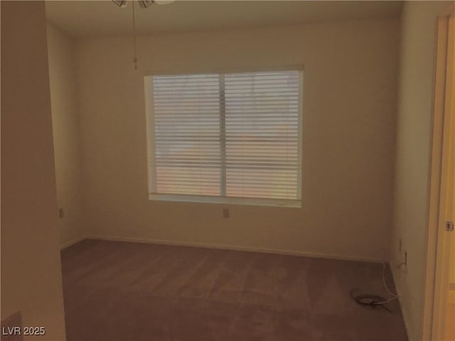 spare room featuring baseboards and carpet