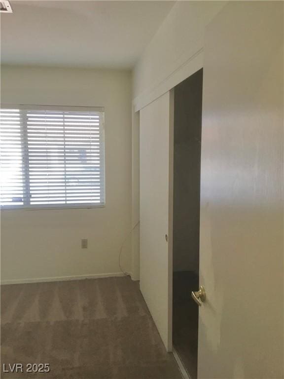 unfurnished bedroom featuring a closet and carpet flooring