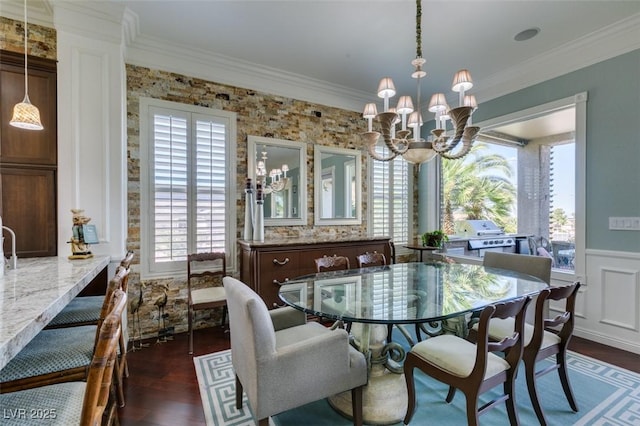 dining area with a wainscoted wall, ornamental molding, and dark wood finished floors