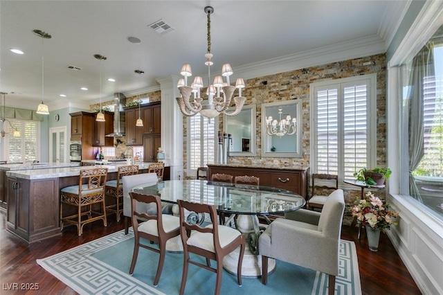 dining area with dark wood finished floors, crown molding, visible vents, and a chandelier