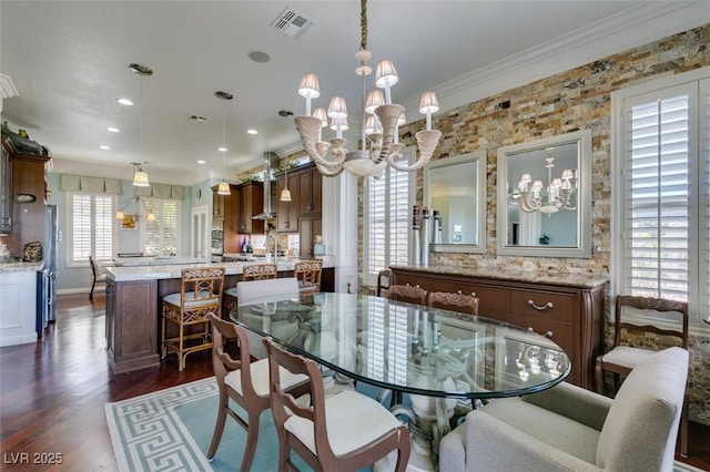 dining area with visible vents, ornamental molding, recessed lighting, an inviting chandelier, and dark wood-style floors