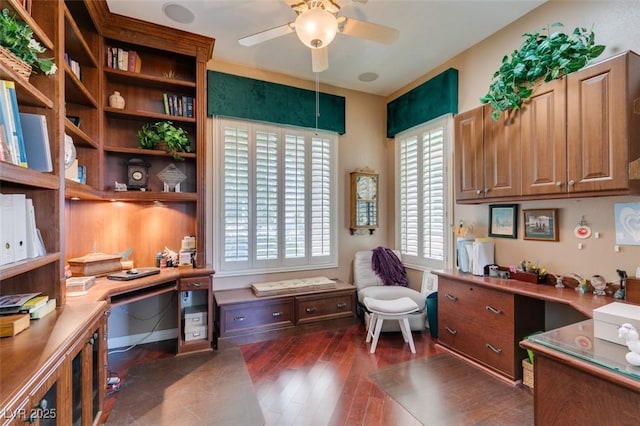 office featuring dark wood finished floors, a ceiling fan, and built in study area