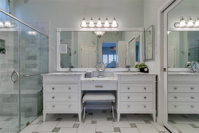 full bath with vanity and a shower stall