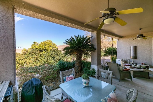 view of patio / terrace featuring area for grilling, outdoor dining area, and ceiling fan