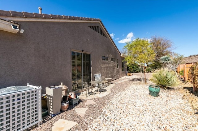 back of house with stucco siding and a patio