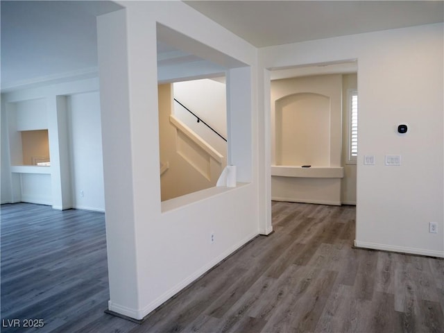 interior space featuring stairway, baseboards, and wood finished floors