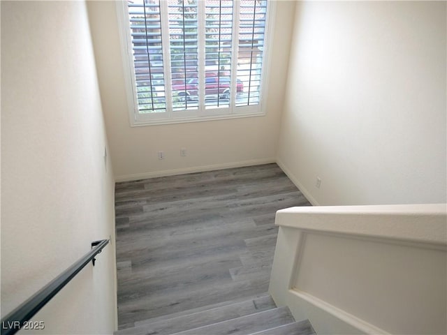 stairs featuring baseboards and wood finished floors