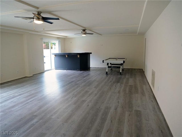 unfurnished living room with wood finished floors, a ceiling fan, and visible vents