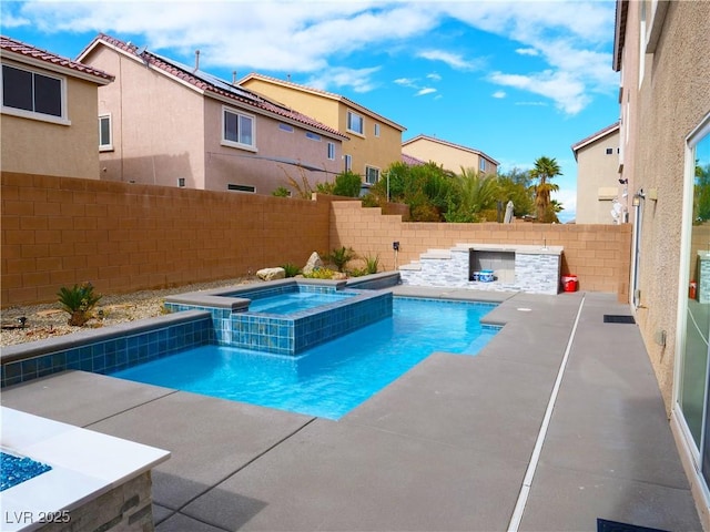 view of swimming pool with a patio area, a fenced backyard, and a pool with connected hot tub