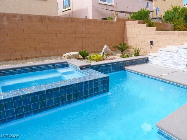 view of pool featuring an in ground hot tub and a fenced backyard