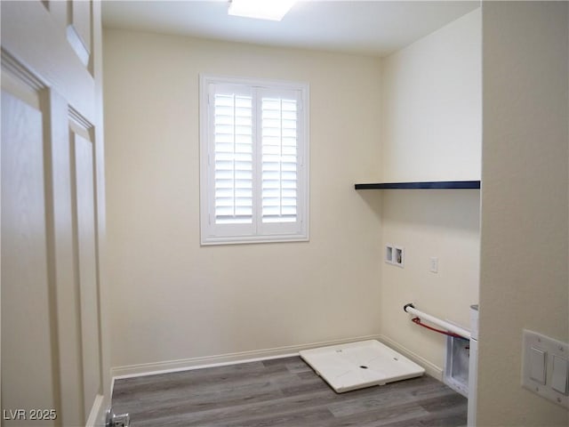 clothes washing area featuring washer hookup, laundry area, wood finished floors, and baseboards